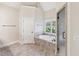 Bathroom with soaking tub, tiled surround, glass shower door, and neutral walls at 528 Bankhead Dr, Cary, NC 27519
