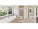 A luxurious soaking tub with a jets and natural light from a window is a wonderful place to relax at 528 Bankhead Dr, Cary, NC 27519