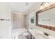 Neutral bathroom featuring a shower-tub combo and a dark wood vanity with a white countertop and natural light at 528 Bankhead Dr, Cary, NC 27519