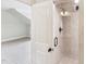 Tiled shower stall with shower head and handle visible through the open bathroom doorway at 528 Bankhead Dr, Cary, NC 27519