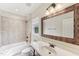 Neutral bathroom featuring a shower-tub combo and a dark wood vanity with a white countertop and natural light at 528 Bankhead Dr, Cary, NC 27519