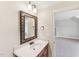 Bathroom vanity featuring a unique mirror and bright natural light from the adjacent window at 528 Bankhead Dr, Cary, NC 27519