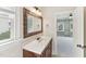 Bathroom vanity featuring a unique mirror and bright natural light from the adjacent window at 528 Bankhead Dr, Cary, NC 27519