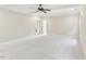 Large carpeted bedroom with a ceiling fan, neutral walls, and white trim at 528 Bankhead Dr, Cary, NC 27519