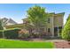 Attractive back exterior featuring stone patio, flower bushes and manicured lawn at 528 Bankhead Dr, Cary, NC 27519