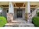 Covered front entrance featuring stone accents, sturdy columns, and flagstone steps at 528 Bankhead Dr, Cary, NC 27519