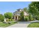 Inviting home showcasing a stone-accented porch and lush landscaping with mature trees at 528 Bankhead Dr, Cary, NC 27519
