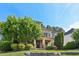 Charming two-story home featuring lush landscaping and a stone-accented front porch at 528 Bankhead Dr, Cary, NC 27519