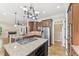 Modern kitchen with granite island, stainless appliances, and wood cabinets at 528 Bankhead Dr, Cary, NC 27519