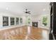 Bright living room with a fireplace, hardwood floors, and large windows at 528 Bankhead Dr, Cary, NC 27519