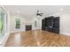 Spacious living room featuring a fireplace, built-in shelving, and multiple windows at 528 Bankhead Dr, Cary, NC 27519