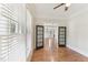 Bright living room featuring hardwood floors, large windows, and an open doorway at 528 Bankhead Dr, Cary, NC 27519