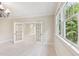 Sitting area with French doors, carpet, neutral walls, chandelier and window at 528 Bankhead Dr, Cary, NC 27519