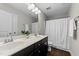 Well-lit bathroom features double sink vanity with modern fixtures and shower with curtain at 5292 Goosecross Way, Fuquay Varina, NC 27526