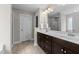 Bright bathroom features a double sink vanity with marble countertops and a glass shower at 5292 Goosecross Way, Fuquay Varina, NC 27526
