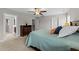 Bedroom features a ceiling fan and connected bathroom and staircase at 5292 Goosecross Way, Fuquay Varina, NC 27526
