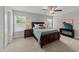 Bedroom features carpet, ceiling fan, lamps, multiple windows for lots of natural light at 5292 Goosecross Way, Fuquay Varina, NC 27526