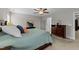 Bedroom with a ceiling fan and furnishings; dresser, lamps, and artwork at 5292 Goosecross Way, Fuquay Varina, NC 27526