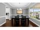Elegant dining room with tray ceilings, chandelier, and view of the front yard at 5292 Goosecross Way, Fuquay Varina, NC 27526