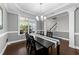 Dining room featuring hardwood floors, large windows, and modern decor at 5292 Goosecross Way, Fuquay Varina, NC 27526