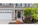 Charming front porch with stone accents and a decorative wreath on the front door at 5292 Goosecross Way, Fuquay Varina, NC 27526