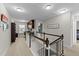 Upstairs hallway with carpet, built-in desk, and railing with white balusters at 5292 Goosecross Way, Fuquay Varina, NC 27526