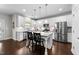 Modern kitchen with white cabinets, granite countertops, and stainless steel appliances at 5292 Goosecross Way, Fuquay Varina, NC 27526