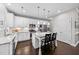 Spacious kitchen with white cabinets, center island, and hardwood floors at 5292 Goosecross Way, Fuquay Varina, NC 27526