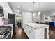 Bright kitchen with granite countertops, stainless steel appliances, and hardwood floors at 5292 Goosecross Way, Fuquay Varina, NC 27526