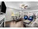 Comfortable living room featuring hardwood floors and an open floor plan into kitchen area at 5292 Goosecross Way, Fuquay Varina, NC 27526