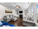 Warm living room with built-in shelving, a fireplace, and natural light at 5292 Goosecross Way, Fuquay Varina, NC 27526