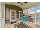 Inviting screened porch with neutral tones, ceiling fan, stylish rug and chairs, creating an ideal outdoor living space at 5292 Goosecross Way, Fuquay Varina, NC 27526