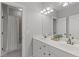 Well-lit bathroom featuring double sinks, white cabinets, and a shower with a curtain at 5410 Highcroft Dr, Cary, NC 27519