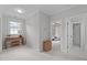 Light-filled bedroom featuring neutral walls, a side table, and an adjoining room entrance at 5410 Highcroft Dr, Cary, NC 27519