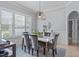 Dining room with six chairs, table with floral arrangements and large windows with shutter blinds at 5410 Highcroft Dr, Cary, NC 27519