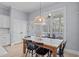 Dining room features a wooden table, stylish lighting, and access to the deck through large windows at 5410 Highcroft Dr, Cary, NC 27519