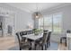 Dining room features a large dining table with velvet chairs, stylish chandelier and large window at 5410 Highcroft Dr, Cary, NC 27519
