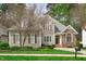 Beautiful home showcasing stone accents, complemented by a lush green lawn and mature landscaping at 5410 Highcroft Dr, Cary, NC 27519