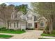 Charming two-story home featuring a blend of stone and siding, well-manicured lawn and a welcoming entrance at 5410 Highcroft Dr, Cary, NC 27519