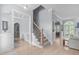 Spacious foyer with staircase and views to other rooms, hardwood floors, and light blue walls at 5410 Highcroft Dr, Cary, NC 27519