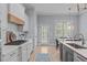Bright kitchen with white cabinets, a large island with seating, and modern appliances at 5410 Highcroft Dr, Cary, NC 27519