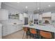 Well-lit kitchen with stainless steel appliances, white cabinetry, and a spacious center island at 5410 Highcroft Dr, Cary, NC 27519