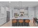 Bright kitchen with a large center island, white cabinets, and stainless steel appliances at 5410 Highcroft Dr, Cary, NC 27519