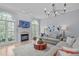 Open living room featuring a fireplace, modern decor, and plenty of natural light at 5410 Highcroft Dr, Cary, NC 27519