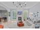 Comfortable living room with a fireplace, elegant lighting, and a view into the dining area at 5410 Highcroft Dr, Cary, NC 27519
