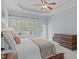 Comfortable main bedroom featuring a ceiling fan, large windows, and access to the outdoors at 5410 Highcroft Dr, Cary, NC 27519