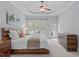 Cozy main bedroom with a ceiling fan, natural light, and a view of the outdoors at 5410 Highcroft Dr, Cary, NC 27519