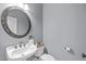 Modern powder room featuring a decorative mirror, stylish sink, and well-placed fixtures at 5410 Highcroft Dr, Cary, NC 27519