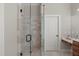 Tiled shower with glass door and black hardware is conveniently adjacent to vanity and toilet at 5410 Highcroft Dr, Cary, NC 27519