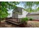 The backyard offers a wooden deck perfect for outdoor entertaining or relaxing, surrounded by trees at 5410 Pageford Dr, Durham, NC 27703
